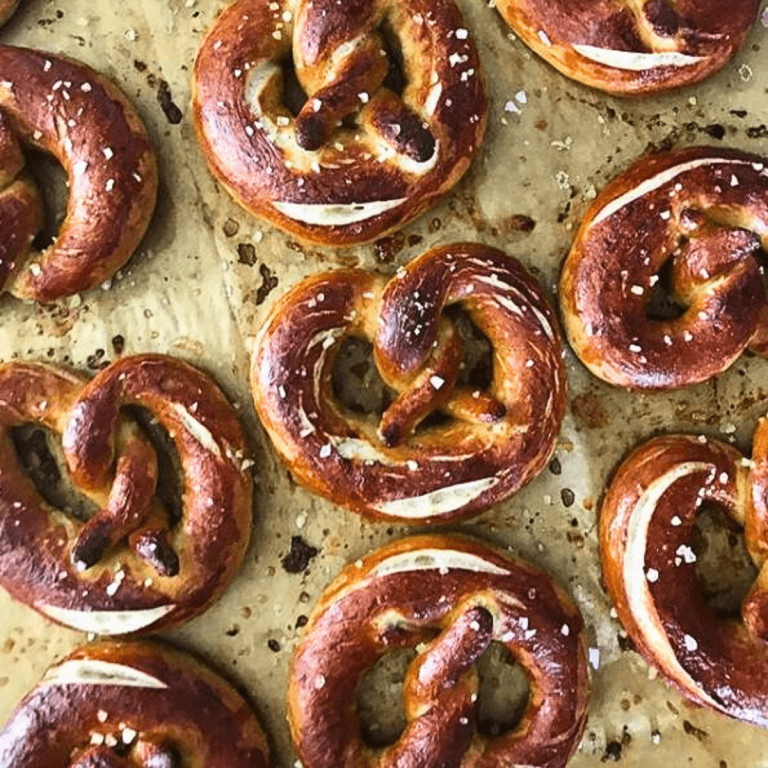 sourdough soft pretzels arranged on a parchment paper after baking