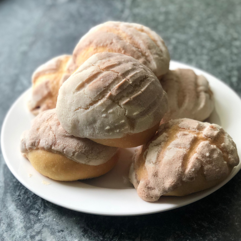 sourdough pan dulce rolls sitting on a plate