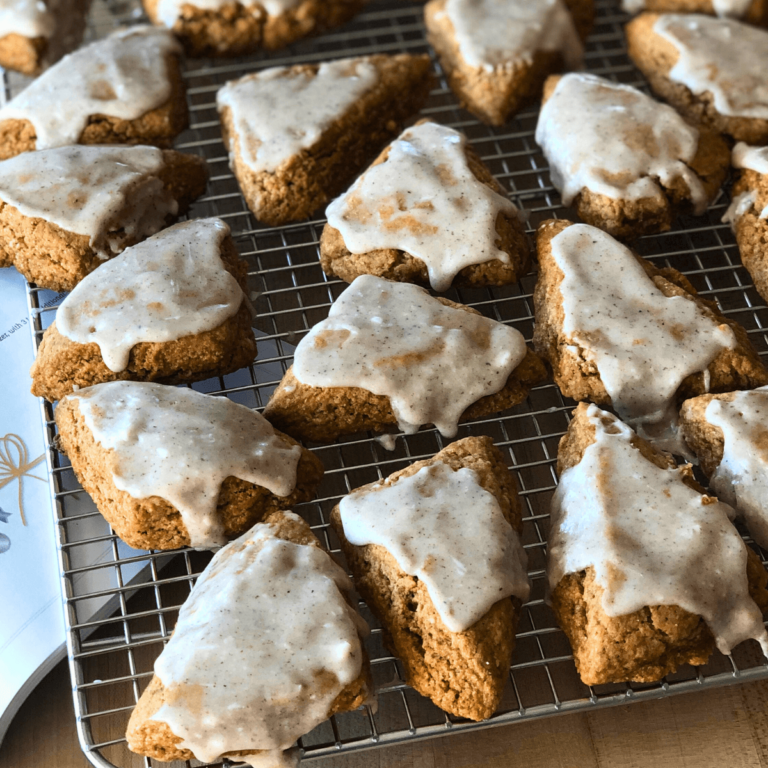 sourdough gingerbread scones with eggnog icing on a wire cooling rack