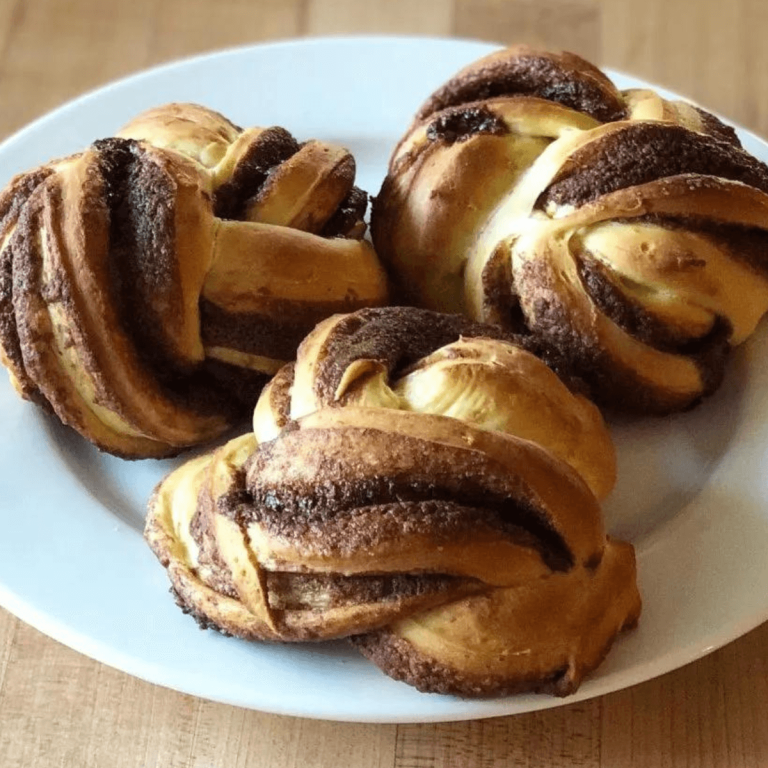 3 Sourdough Orange Chocolate Mini Babkas for St. Nicholas on a white plate on a wood butcher block table