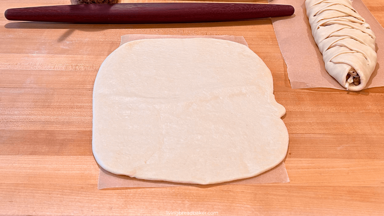 Sourdough Meat Filled Braided Bread, rectangle of dough rolled out for filling on top of parchment paper