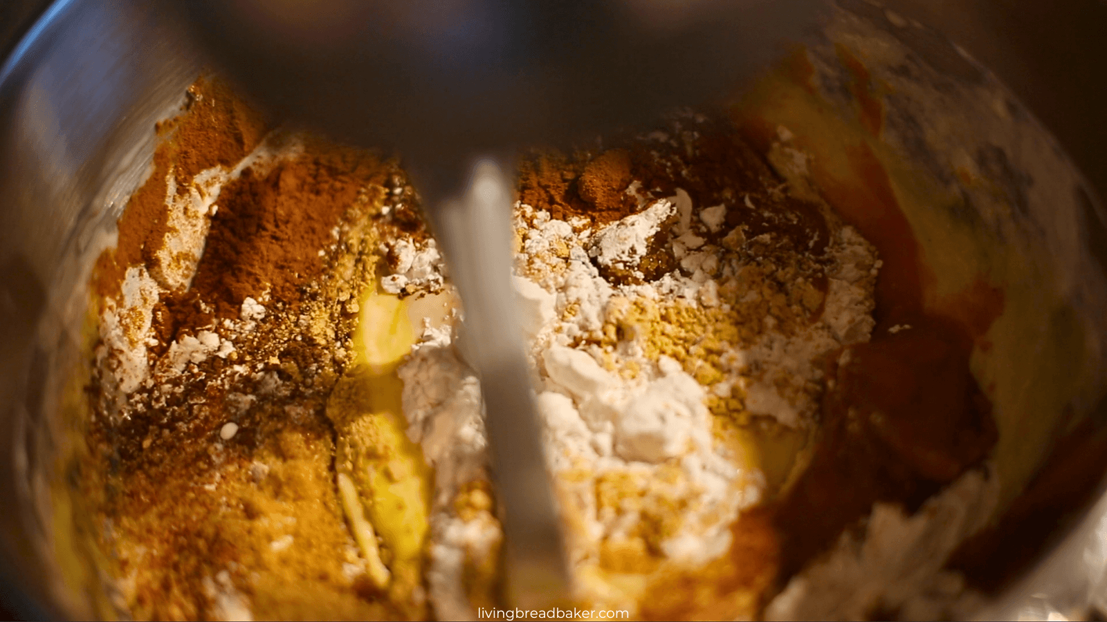 sourdough pumpkin spice waffle batter mixing in the spices and dry ingredients