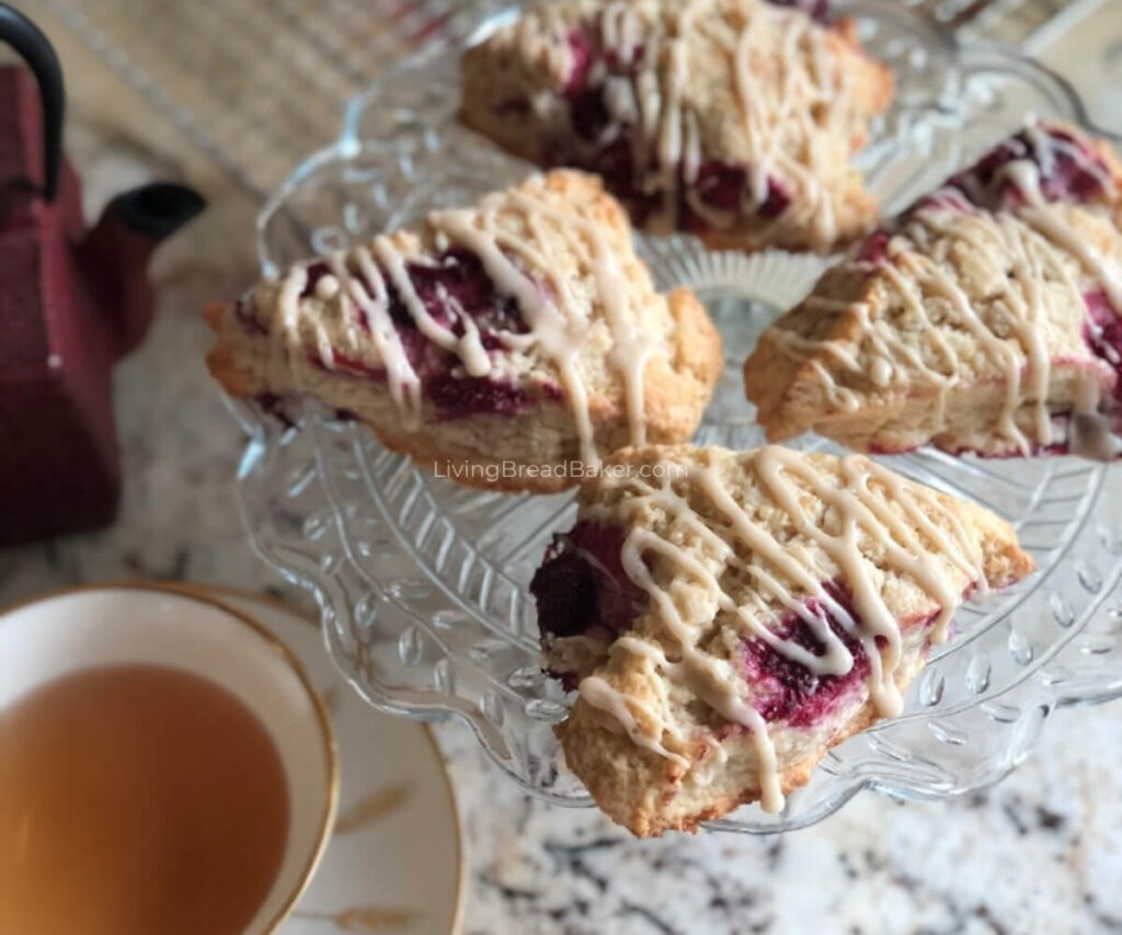Best Sourdough Discard Raspberry Vanilla Scones blog image_ on cake stand with tea 